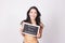 Young woman holding chalkboard saying Beach body workout