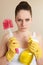 Young Woman Holding Cleaning Products Looking Unhappy