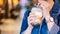 Young woman is holding, drinking brown sugar flavored tapioca pearl bubble milk tea with glass straw in night market of Taiwan,