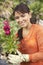 Young Woman Holding Flower Plant