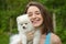 Young woman holding german spitz puppy