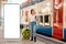 Young woman holding her luggage and waiting departure. Big smartphone with mock up and copy space. Train station is in