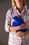 Young Woman Holding Hot Water Bottle Against Stomach