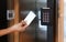 Young woman holding a key card to lock and unlock door.