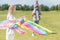 young woman holding  kite while father carrying little daughter on neck behind