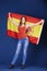 Young woman holding a large Spanish flag