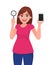 Young woman holding magnifying glass. Girl showing new digital mobile phone or smartphone. Female character design illustration.