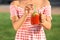 Young woman holding mason jar with refreshing watermelon lemonade outdoors, closeup