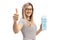 Young woman holding a milk carton and making a thumb up sign