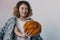 Young woman holding orange merino wool ball