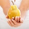 Young woman holding pear