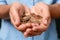 Young woman holding pile of coins,  view