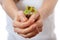 Young woman holding plant, coleus sprout