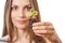 Young woman holding plant, coleus sprout