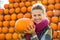 Young woman holding pumpkin