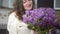 Young woman holding purple tulip flowers bouquet