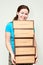 Young woman holding several boxes