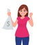 Young woman holding/showing cash, money, currency note bag with dollar sign and raised hand fist with happy winning or success.