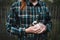 Young woman holding a small, cute bunny. Farmer holding rabbit. Concept of farm and animals.