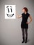 Young woman holding smiley face drawing