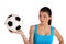 Young woman holding a soccer ball with a skeptical