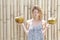 Young woman holding two fresh coconuts