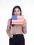 Young woman holding the US flag, smiling and looking at the camera with a white background. Space for Text. 4th of July. Celebrate