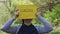 Young woman holding a yellow piece of paper with success spelled