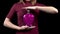 Young woman holds a bottle with a love potion. Glass bottle in the form of a heart with pink liquid. Valentine`s Day is