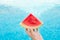 Young Woman Holds in Hand Wedge Slice of Juicy Watermelon by Swimming Pool. Blue water. Sunlight. Vacation Relaxation