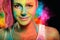 Young woman with holi paints against a rainbow color explosion