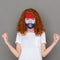 Young woman with Holland flag painted on her face