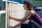 Young woman in a home diy project making a fence