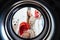 Young woman at home puts the dress in the drying machine.