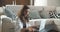 Young woman at home schooling. A young woman studying or working on a laptop. Checks for messages on the phone.