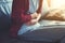 Young woman at home sitting on sofa with hands on stomach