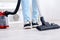 Young woman hoovering in living room