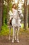 Young woman on a horse. Horseback rider, woman riding horse