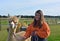 Young woman with an Huacaya alpaca, outdoors