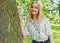 Young woman hugging a big tree on a summer day. Ecofriendly or nature concept