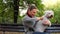 Young woman hugging her white dog in the park outdoor