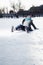 Young woman on ice rink, lying on the ice