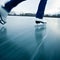 Young woman ice skating outdoors on a pond