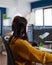 Young woman industrial engineer working at pc with two monitors