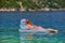 Young Woman in inflatable Matress in the Sea