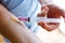 Young woman injecting syringe with sugar hearts in her arm. Concept of diabetes.