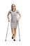 Young woman with an injured leg walking with crutches