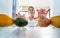 Young woman inside kitchen choosing organic fruits for making fresh extracted juice - Happy girl having fun at home preparing a