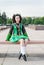 Young woman in irish dance dress sitting on the bench