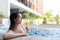 Young Woman in jacuzzi pool and enjoy drink